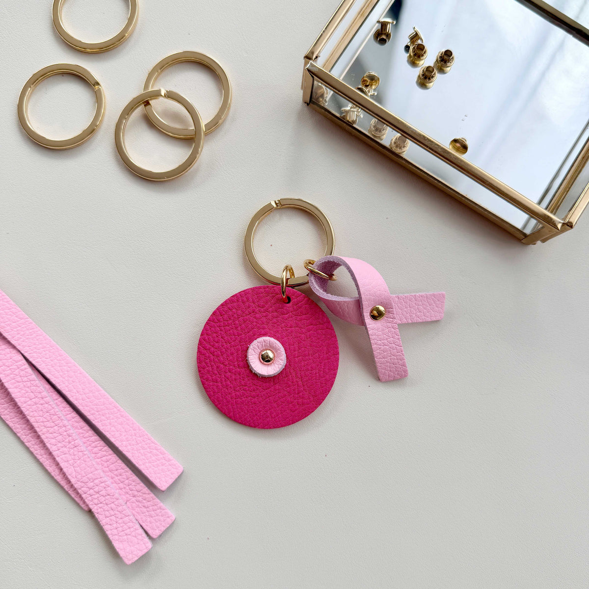 Porte-clés rond Atelier Guillocher en cuir pleine fleur rose pour Octobre Rose avec ruban solidaire
